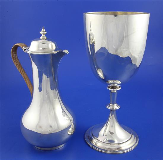 A Victorian silver baluster hot water pot and a later silver presentation trophy cup, gross 25 oz.